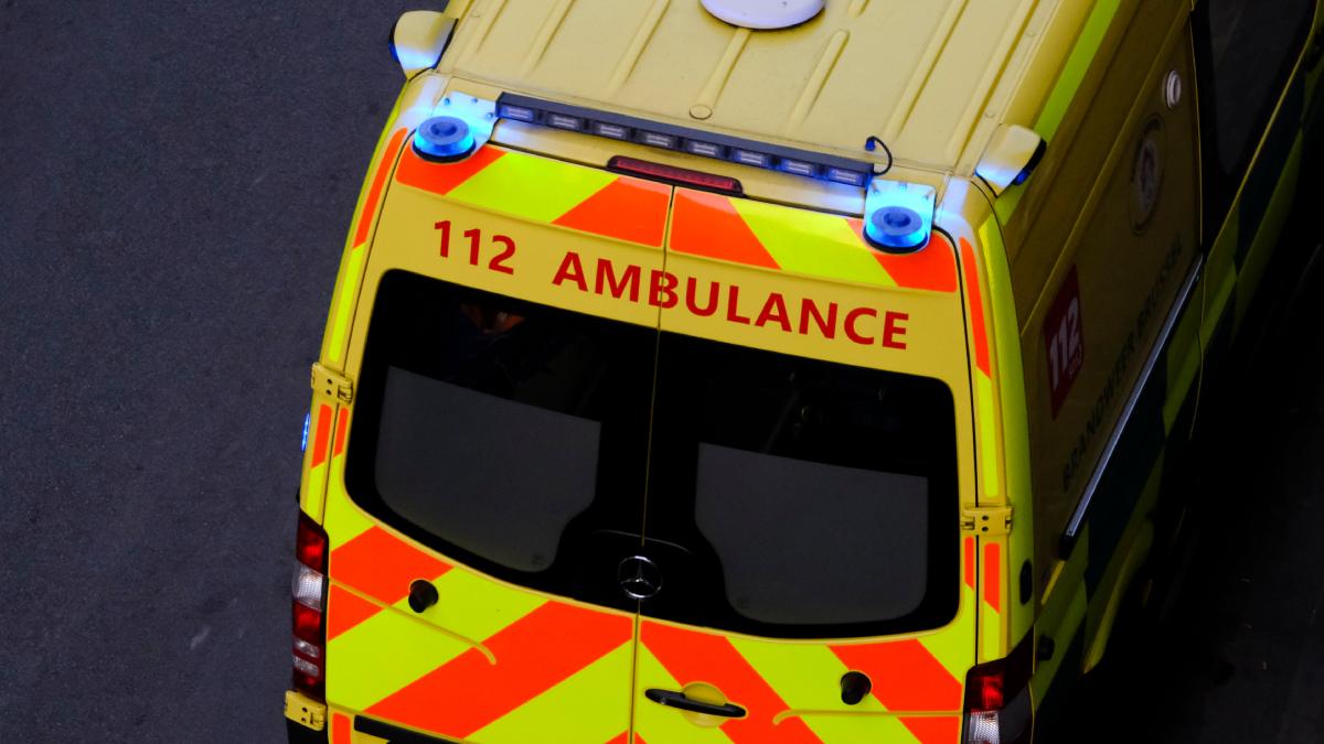 Ambulance belge dans une rue en pleine intervention.